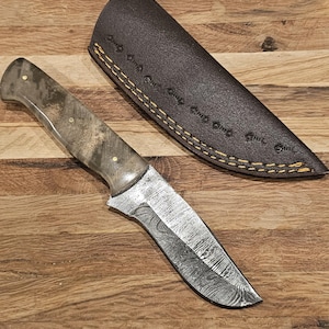 Handmade full tang damascus steel knife. Unique clear handle. Leather sheath included