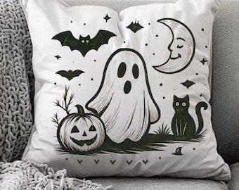 May include: White Halloween-themed pillow featuring a ghost, jack-o'-lantern, black cat, bats, and a crescent moon. The design is in black and white, perfect for seasonal home decor. The pillow is on a gray couch with a gray knitted throw.
