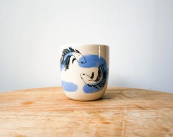 Handcrafted ceramic mug for coffee or tea, featuring a blue fish design, carp, astrological sign, and animal motif, screen-printed.