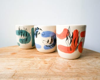 Colorful handcrafted ceramic mug for tea or coffee - handmade pottery mug decorated with colorful paint, fish, seaweed, and animals - Christmas gift idea