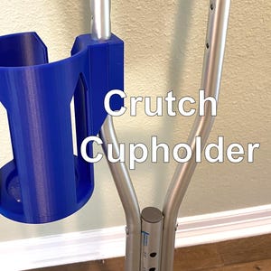 May include: A blue crutch cup holder attached to a silver crutch. The cup holder is made of plastic and has a cylindrical shape with cut-out designs. The text "Crutch Cup Holder" is displayed on the image.