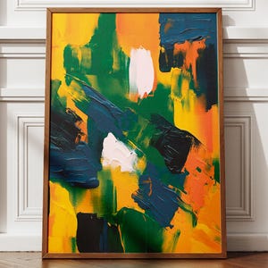 May include: Abstract art painting in a wooden frame. The artwork features bold brushstrokes of yellow, green, orange, navy blue, black, and white. The painting is leaning against a white wall with a shadow.