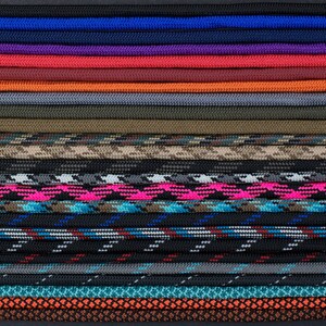 May include: A variety of 25 different colors and patterns of paracord, a type of strong nylon cord often used for crafting and survival.