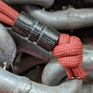 Wide Edge Medium Black Micarta Bead With 2 Grooves and a Free Paracord Lanyard