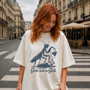 Oversized White leftist shirt featuring a retro praying mantis graphic for nature lovers.
