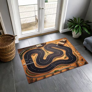 May include: A brown and orange rug with a black race track design. The track is winding and has white lines. The rug is on a wooden floor.