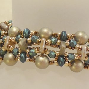 May include: A multi-strand bracelet featuring gold, brown, and teal beads. The bracelet is crafted with a variety of different bead shapes and sizes.