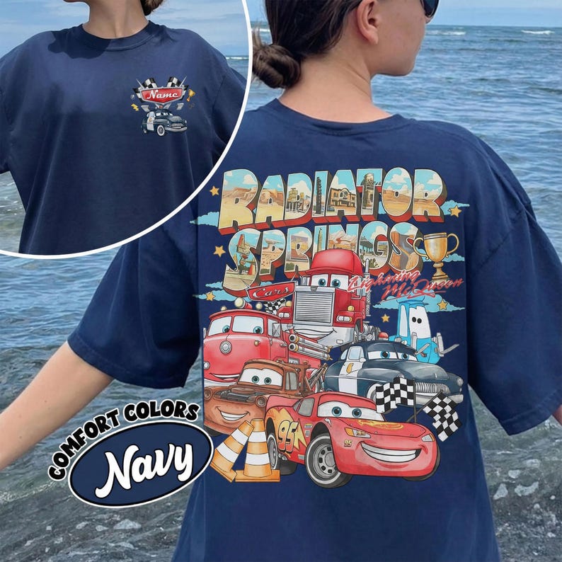 May include: Navy blue t-shirt with a graphic of characters from the film Cars, and the text "Radiator Springs" on the back. The front has a small car graphic with the word "Name". The shirt also has the words "Comfort Colors" and "Navy".