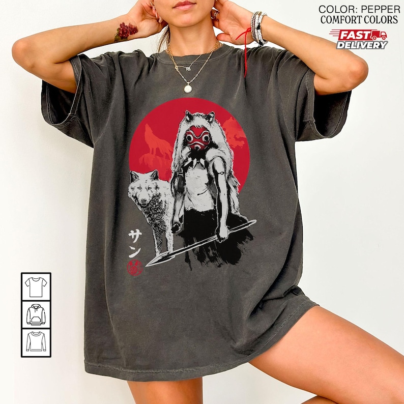 May include: Pepper-colored t-shirt featuring a graphic of a woman with a wolf, a red circle, and Japanese text. The design is in black and white with red accents. The shirt has short sleeves and a relaxed fit.