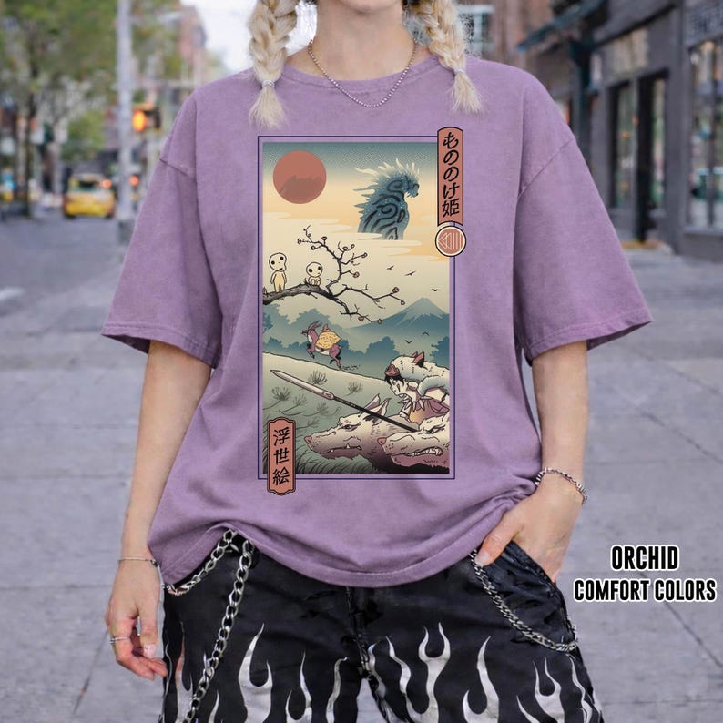 May include: Orchid-colored t-shirt featuring a Japanese anime-style illustration. The graphic depicts a scene with characters, a red sun, and text in Japanese. The shirt is part of the Comfort Colors collection.