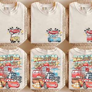 May include: Off-white t-shirts with cartoon car designs. The top row has a checkered flag and a name field, each with a different car. The bottom row shows a larger graphic with multiple cars and the text "Radiator Springs".