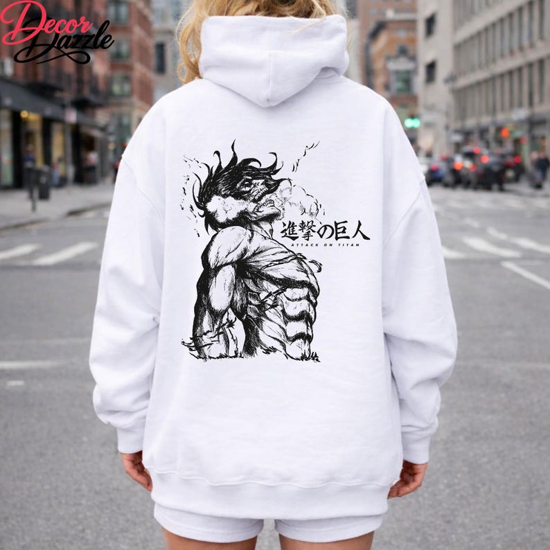 May include: White hoodie with a black and white graphic of a muscular figure with spiky hair and Japanese text. The hoodie has a drawstring hood and long sleeves. The graphic is on the back of the hoodie.