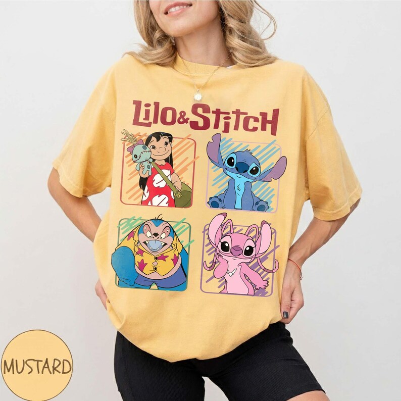 May include: Mustard yellow t-shirt featuring the words "Lilo & Stitch" above four character illustrations. The illustrations include Lilo, Stitch, and other characters from the animated movie. The shirt is a casual, oversized fit.