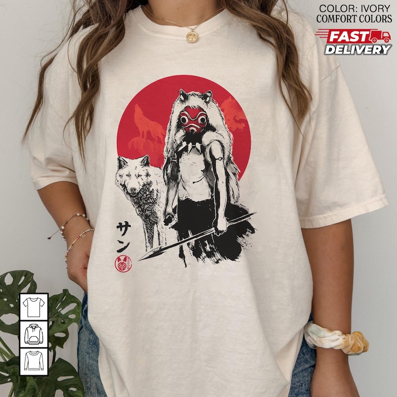 May include: Ivory-colored t-shirt featuring a graphic of a figure with a wolf, set against a red circle with wolf silhouettes. The figure wears a mask and holds a spear. Japanese text is also visible.