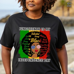 May include: Black t-shirt with a graphic celebrating Juneteenth. The design features the text "Juneteenth is My Independence Day" with a portrait of a Black woman wearing sunglasses with the American flag design. The design also includes words like "Talented", "Loving", and "Beautiful".
