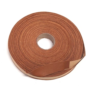 May include: A roll of brown leather cord, wound tightly and ready to be used for crafting projects.