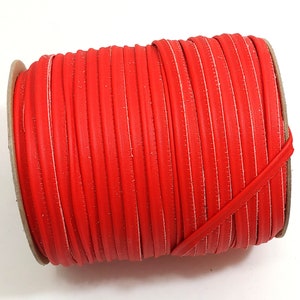 May include: A roll of bright red leather cord, perfect for crafting projects.