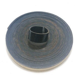 May include: A roll of black rubber weather stripping with a beige backing. The roll is coiled and the end is visible with the text "1/2"C D".