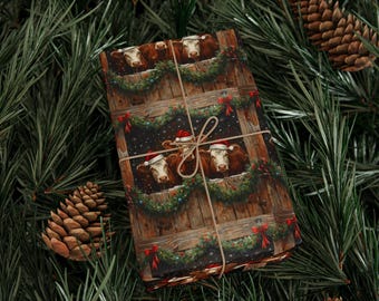 May include: Wrapped gift with a festive cow print. The wrapping paper features brown and white cows wearing Santa hats, framed by Christmas wreaths and red bows. The gift is tied with twine and set against a backdrop of pine needles and pine cones.