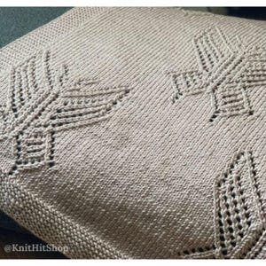 May include: A light beige knitted pillow cover featuring a textured leaf pattern created with openwork stitches. The fabric has a consistent stockinette stitch background with intricate, raised knit details. The text KnitHitShop is visible.