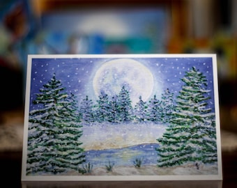 May include: A watercolor painting of a snowy winter scene with a full moon in the sky.  The painting features a group of pine trees covered in snow, with a small lake in the foreground.