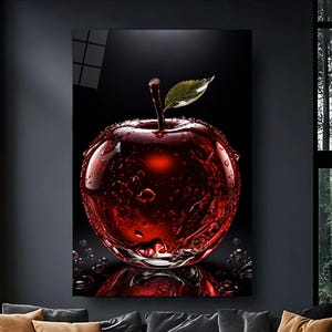 May include: A vertical wall art print featuring a glossy, deep red apple covered in water droplets against a solid black background. The apple has a single green leaf attached to its stem, and its surface reflects light with high contrast.