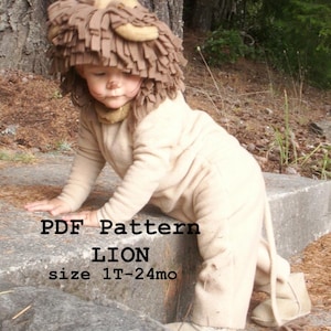 May include: A PDF pattern for a lion costume for a baby or toddler. The pattern is for sizes 12-24 months. The image shows a child wearing the finished costume, which is made of a soft, tan fabric. The costume includes a lion head with a brown mane and a tail.