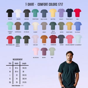 May include: A display of Comfort Colors 1717 t-shirts in various colors, including black, white, and red. The image includes a measurement chart with sizes ranging from S to 2XL, with widths from 18 1/4 inches to 26 inches and lengths from 26 3/5 inches to 31 3/5 inches.