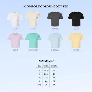 May include: A Comfort Colors boxy tee color chart featuring eight short-sleeve shirts in white, ivory, pepper, black, orchid, chalky mint, chambray, and butter. A measurement table lists sizes S to 2XL with widths from 18.25 to 26 inches and lengths from 20 to 24 inches.