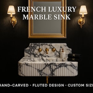 May include: A luxury marble sink with a fluted design, featuring a white and black marble pattern. The sink has gold fixtures and is mounted below a gold-framed mirror. The text "FRENCH LUXURY MARBLE SINK" is displayed above the sink.