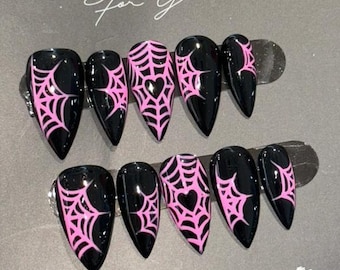 May include: Black press-on nails with pink spiderweb designs and heart accents. The nails are displayed on a gray card with the text "NAIL BOX For You" and "Thank you for choosing us."