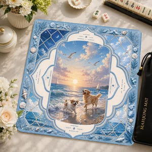May include: A square mahjong mat featuring a central scene of two dogs on a beach at sunset, framed by a light blue border with seashell and coral illustrations. The design includes text elements like "GOOD TIMES," "LUCK," and "ELEGANT LIFE."