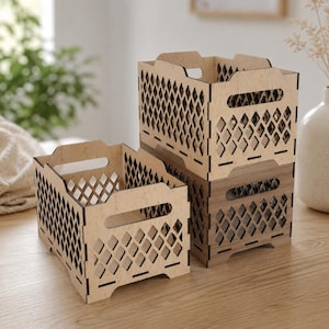 May include: Two rectangular storage crates made of light and dark wood, featuring a laser-cut diamond lattice pattern on all four sides and integrated handles on the top edges. The crates are open-topped and have a modular, interlocking design.