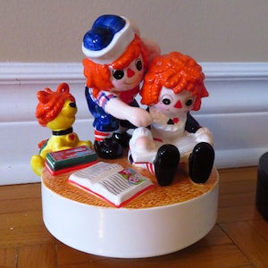 Zabytkowa pozytywka Raggedy Ann i Andy, dzwonek, gra "my favorite things"