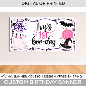 May include: A custom birthday banner with the text "Ivy's 1st boo-day" in black and pink. The banner features a ghost, spiderweb, bat, pumpkin, and witch hat. The words "DIGITAL OR PRINTED" are at the top.