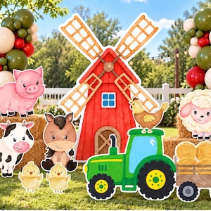May include: A set of farm-themed party decorations featuring a large red windmill, a green tractor pulling a trailer of hay bales, and cartoon-style cutouts of a pig, cow, horse, sheep, and two chicks, accented by balloon arches in red, green, and white.