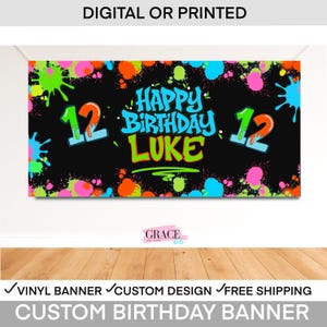 May include: A black custom birthday banner with colorful paint splatters. The banner reads "Happy Birthday Luke" with the number "12" on either side. The banner also says "Digital or Printed".