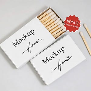 May include: Two white matchboxes with the text "Mockup Houz" in black script. One box is open, revealing wooden matches with white tips. Two loose matches are next to the boxes. A red "BONUS Feature Image" sticker is in the image.