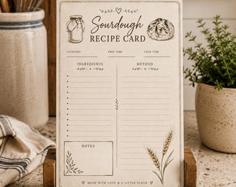 Puede incluir: Una tarjeta de receta de masa madre de papel rectangular en un soporte de madera. La tarjeta presenta el texto Sourdough RECIPE CARD, secciones para categoría, tiempo de preparación, tiempo de cocción, ingredientes, método y notas, con ilustraciones.
