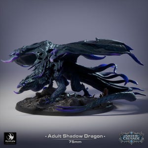 May include: A dark blue and black dragon miniature figurine with purple accents on the wings and tail, standing on a rocky base. The text on the image reads: Adult Shadow Dragon, 75mm, Rescale, and Silver Crusade. The dragon has sharp claws.