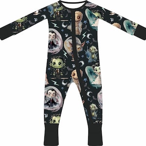 May include: Black and green long-sleeved baby sleeper with a Halloween-themed print featuring various cartoon monsters, including a vampire, Frankenstein, and a mummy.