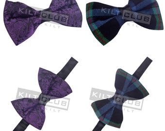 May include: Four bow ties. Two are purple with a floral pattern, and two are navy blue with a plaid pattern. Each bow tie has a black adjustable neck strap. The text "KILT CLUB" is printed on each bow tie.