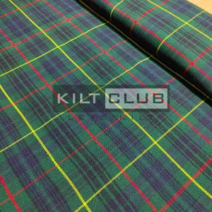 May include: Green, blue, red, and yellow plaid fabric with the text "KILT CLUB" in a white rectangle. The fabric is folded over, showing the pattern's repeating design. The plaid pattern is a classic design.