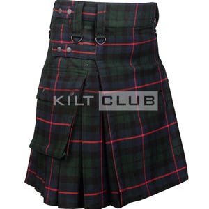May include: A traditional kilt in a dark green, navy, and red plaid pattern. The kilt features pleats, pockets, and adjustable straps with metal hardware. The text "KILT CLUB" is visible on the front.