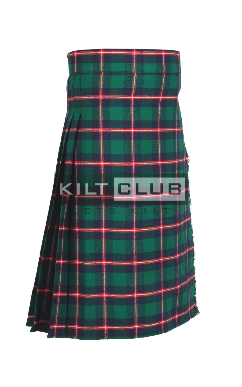 May include: A green, red, and navy plaid kilt with the text "KILT CLUB" in white. The kilt features a pleated design and is made of a woven fabric. The kilt is a traditional garment.