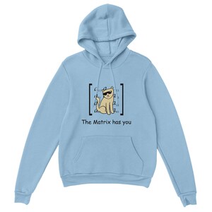 May include: Light blue hoodie with a front pocket and a drawstring hood. The design features a cat wearing sunglasses inside a matrix-style bracket, with the text "The Matrix has you" below the graphic.