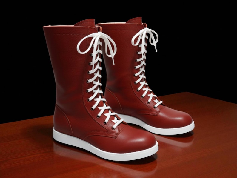 May include: A pair of burgundy-colored boots with white laces and soles. The boots have a mid-calf height and a classic lace-up design. The boots are made of a smooth material and are set against a dark background.