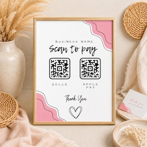 May include: A rectangular sign in a light wood frame featuring the text Business Name, Scan to pay, Zelle, Apple Pay, and Thank You. The design includes two black and white QR codes, a black heart outline, and pink wavy abstract shapes.