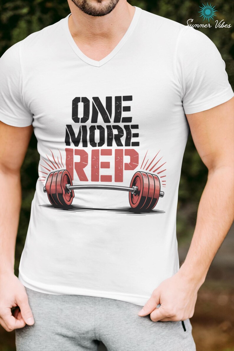 May include: White V-neck t-shirt with the text "ONE MORE REP" above a barbell graphic. The barbell has red weights on each end. The shirt also has the text "Summer Vibes" in the upper right corner.