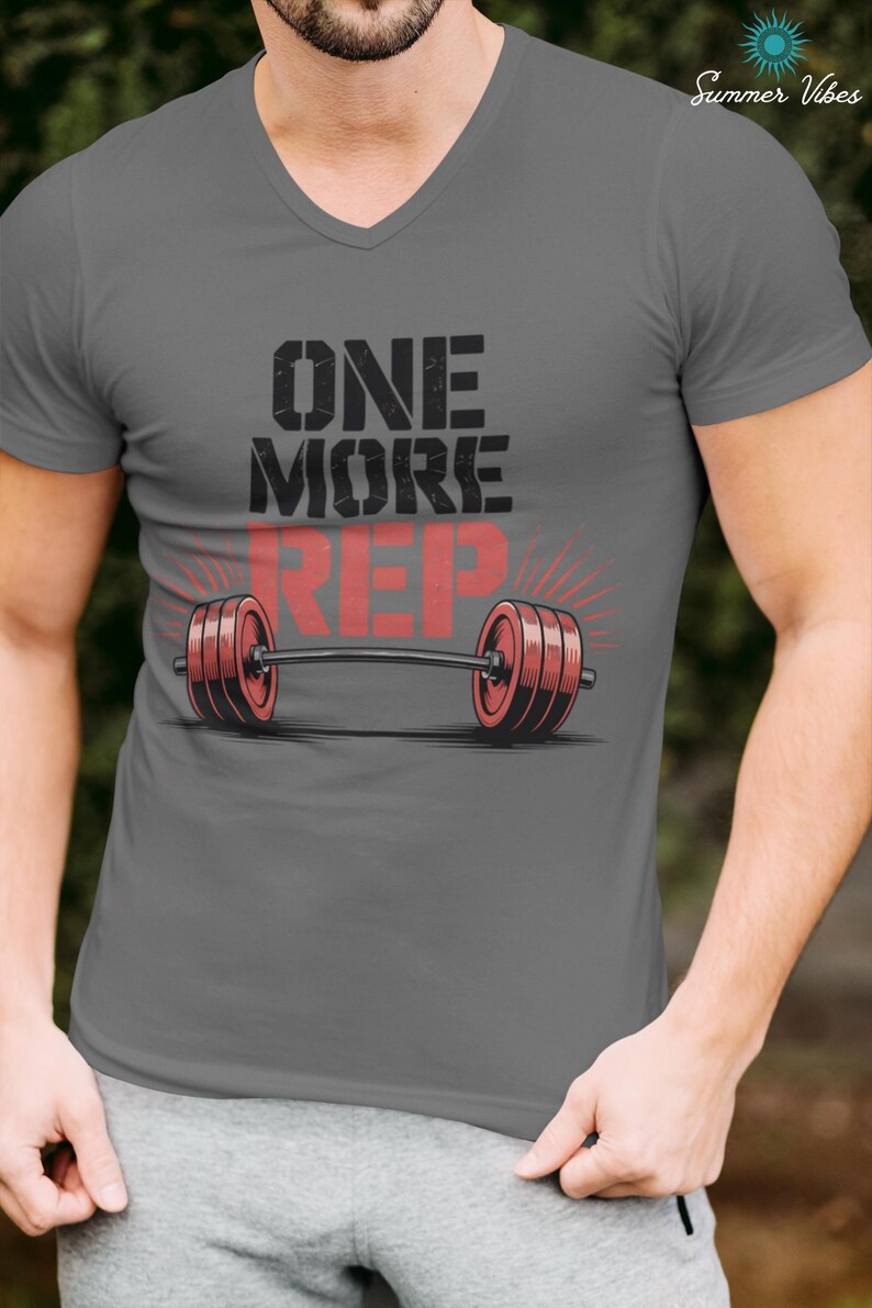 May include: Gray V-neck t-shirt with the text "ONE MORE REP" and a barbell graphic. The barbell has red weights and is centered on the shirt. The words "Summer Vibes" are in the upper right corner.